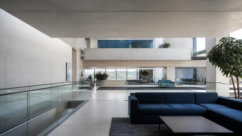 Layered planes of pale concrete and glass in a modern interior
